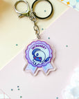 Keychain with a blue quadrupedal fantasy character and 'Introvert' text on a colorful background