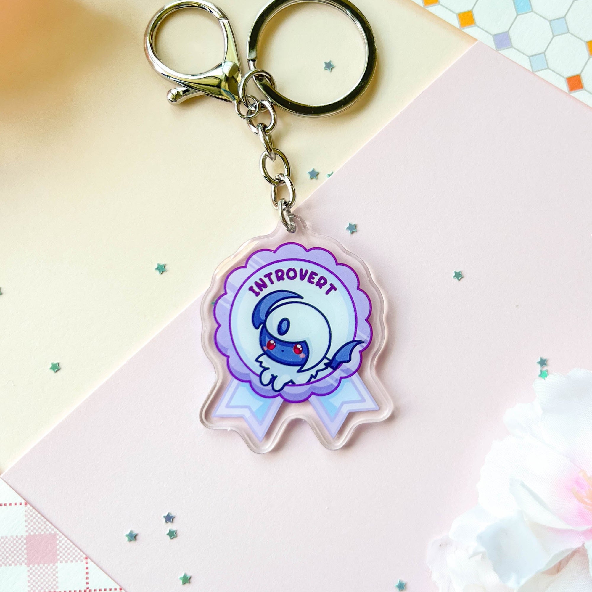 Keychain with a blue quadrupedal fantasy character and 'Introvert' text on a colorful background